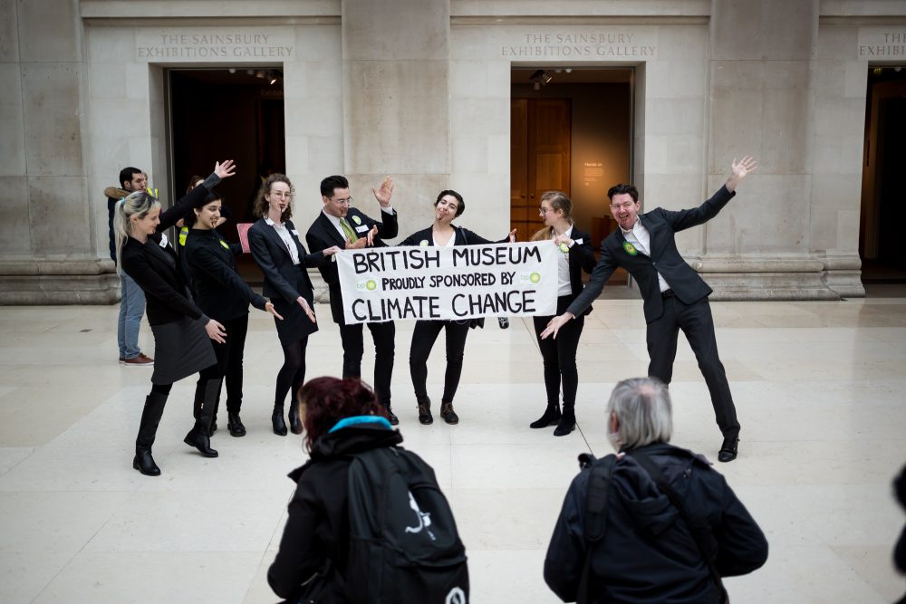 Protestors from Fossil Free London hold a banner about the British Museum's complicity in climate change