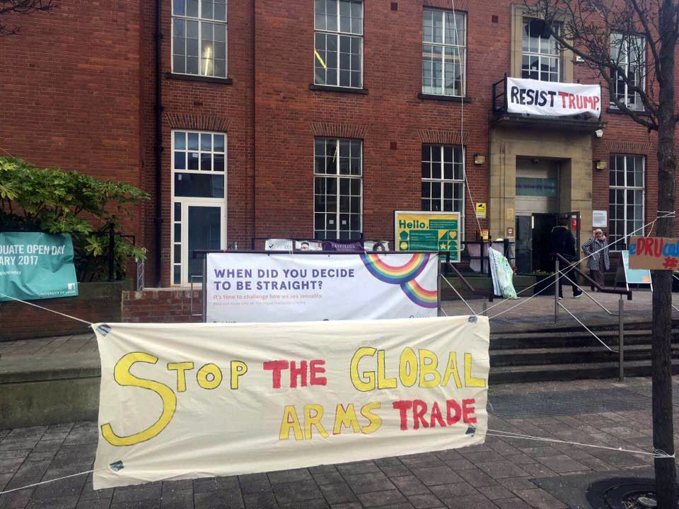 Banner outside Leeds University reading "Stop the Global Arms Trade"